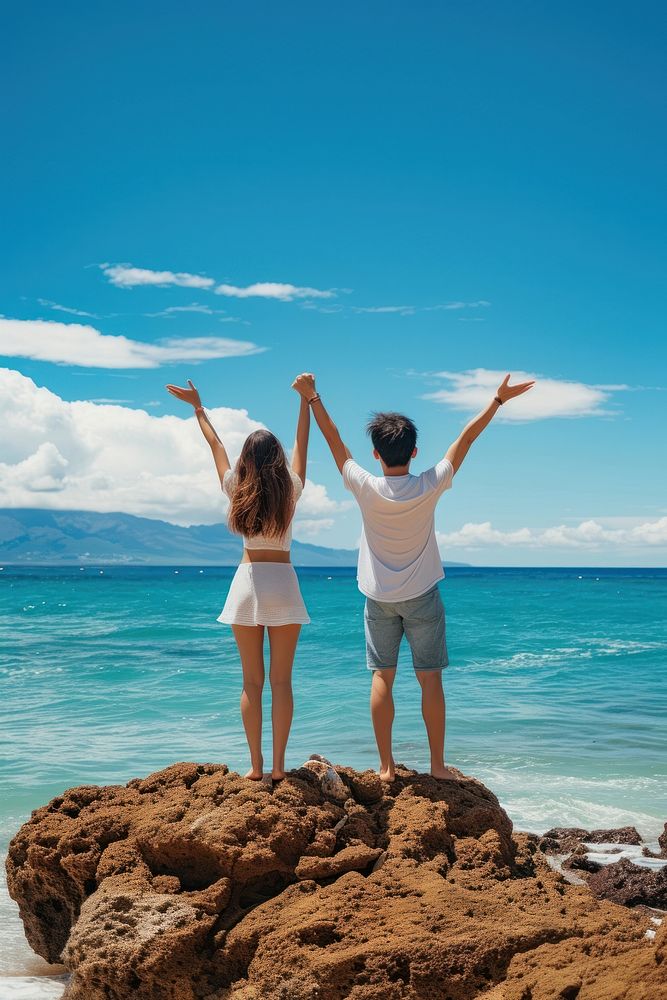 Couple standing on a rock at the beach vacation shorts adult.