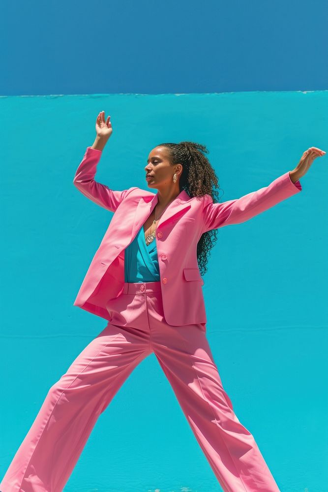 Woman in pink suit in front of blue dancing underwater triumphant happiness.