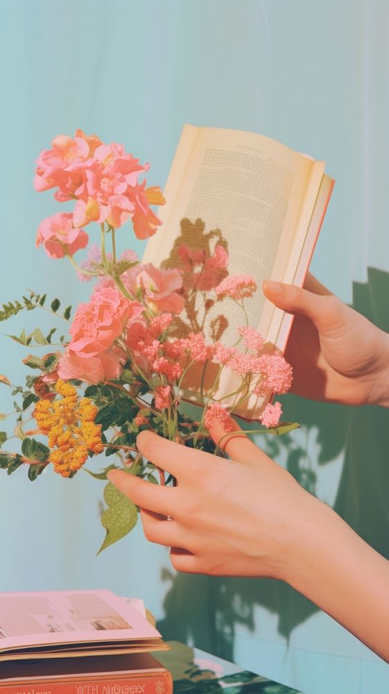 Hand with book publication flower plant.