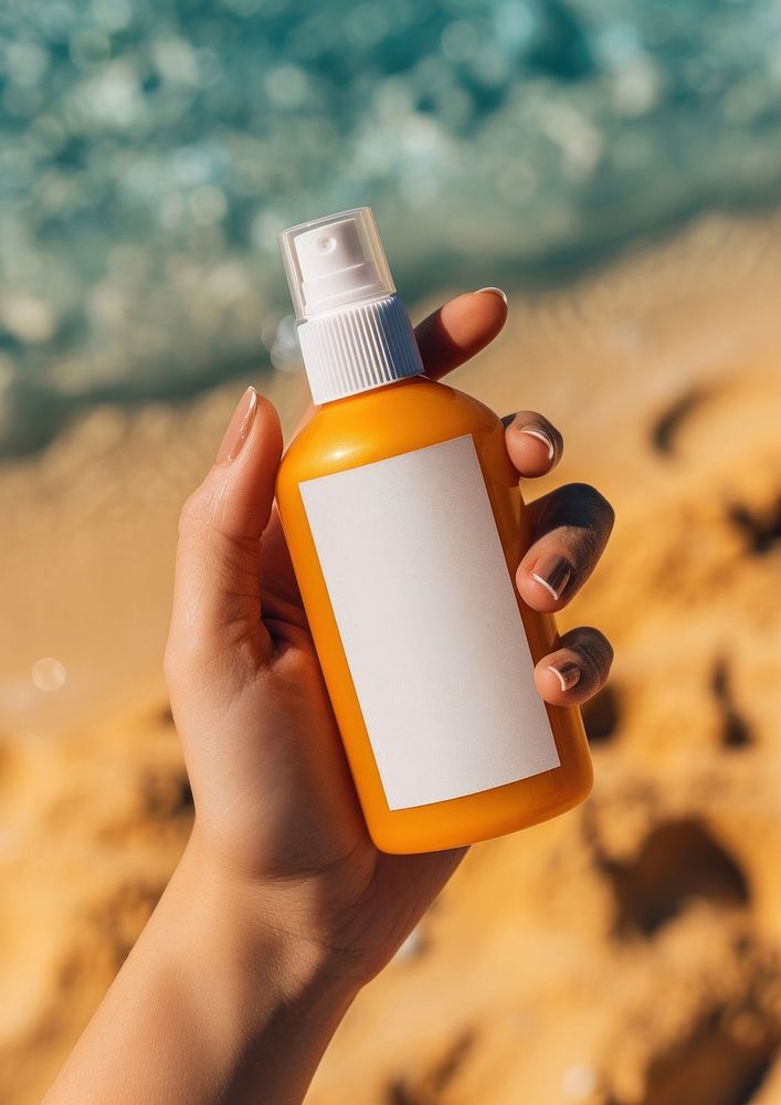 Woman holding a bottle of sunscreen spray cosmetics beach refreshment.