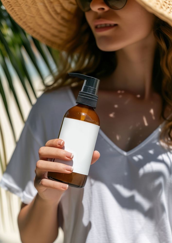 Woman holding a bottle of sunscreen spray drink milk refreshment.