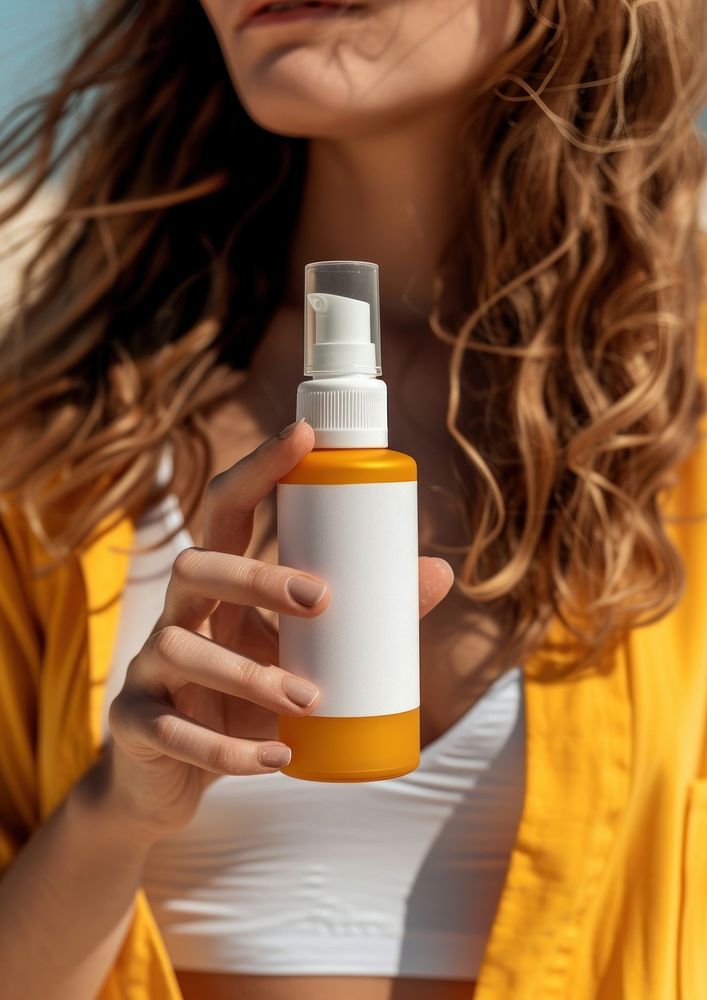 Woman holding a bottle of sunscreen spray container hairstyle cosmetics.