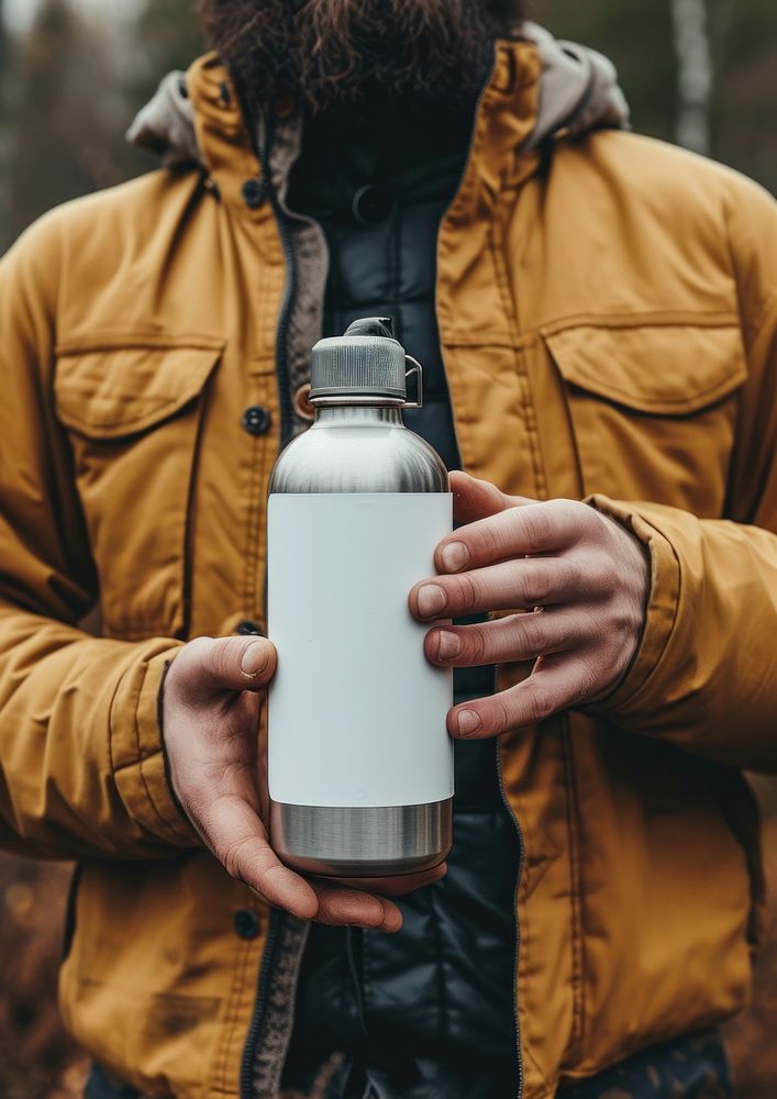 Man holding a bottle of steel thermo photo refreshment photography.