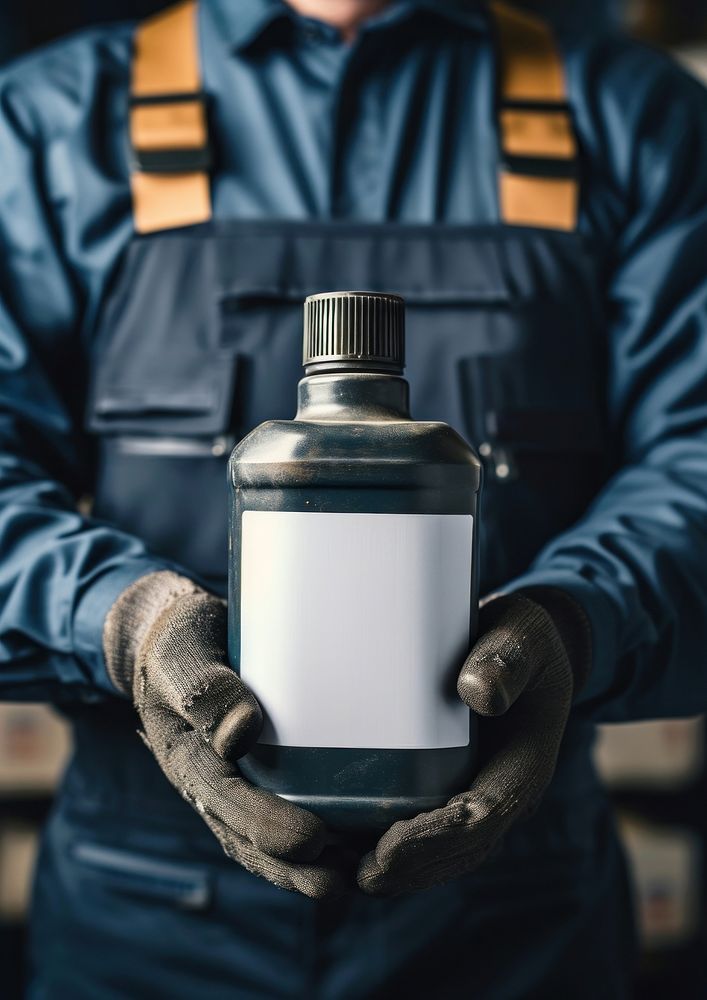 Man holding a canister with machine oil for car bottle adult protection.