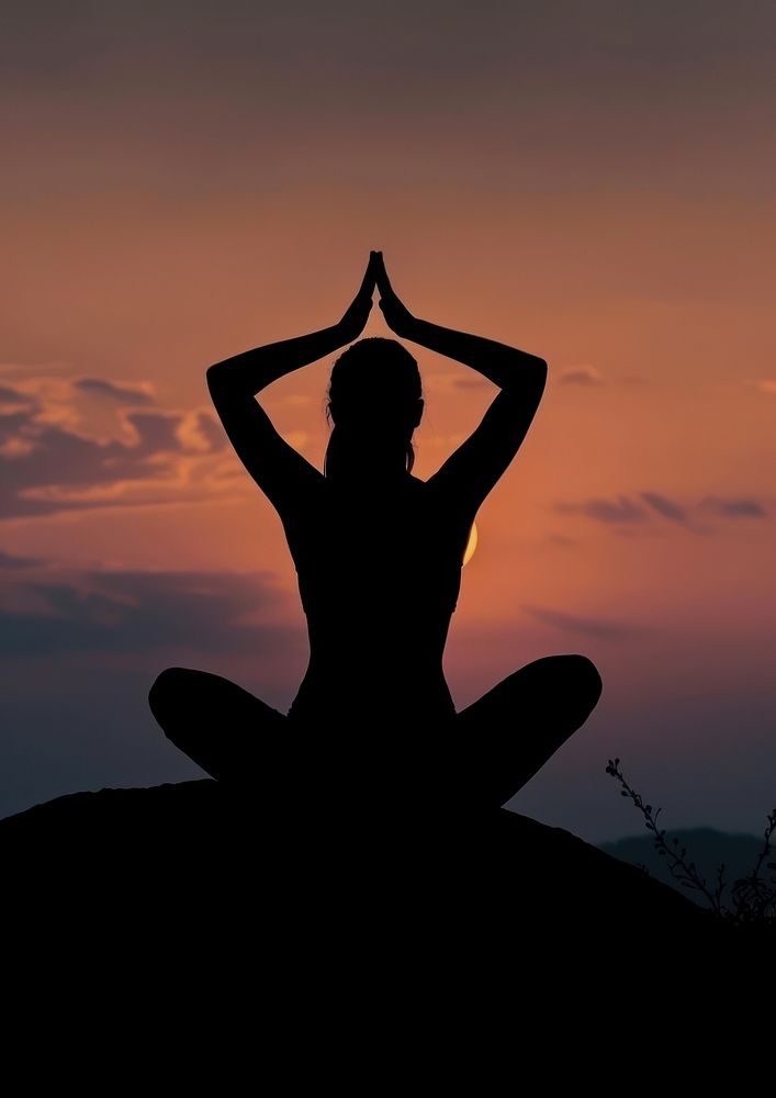 A woman silhouette sitting put the hand together above the head or doing yoga on the mountain in front of the moon…