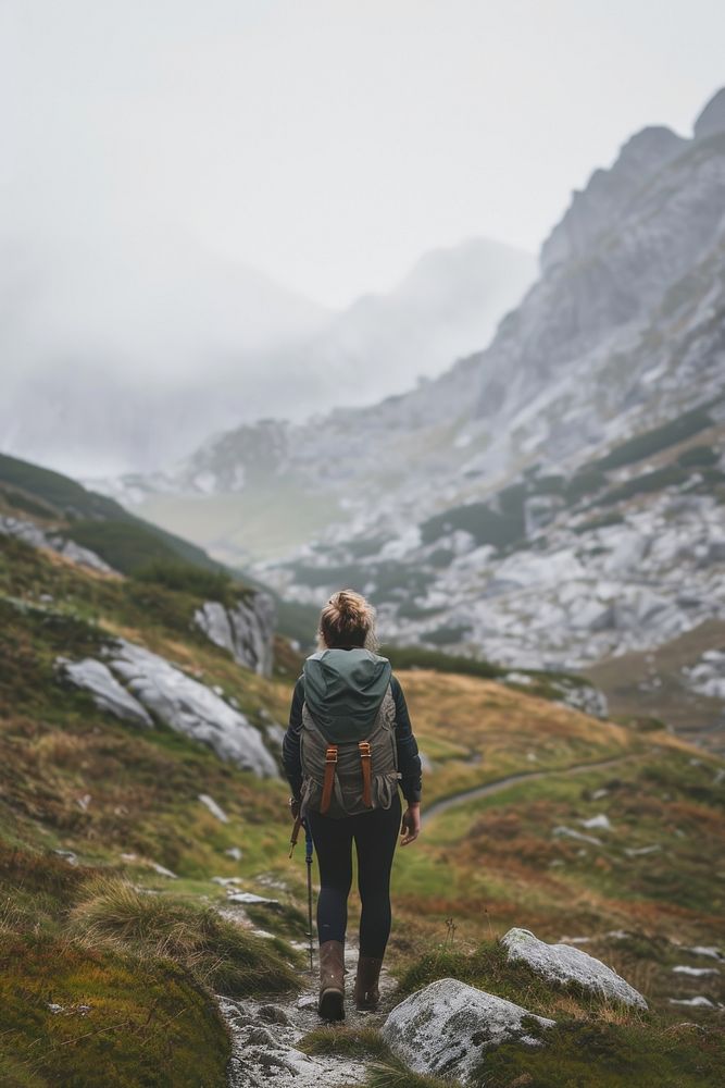 Woman hiking in the mountains standing backpack adult.