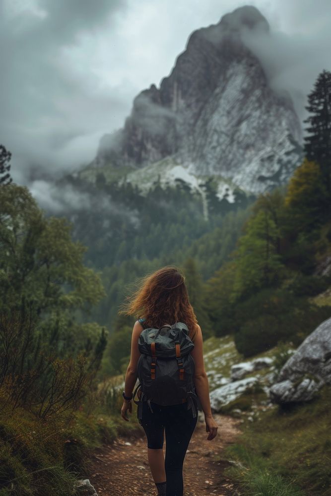 Woman hiking in the mountains adventure backpacking outdoors.