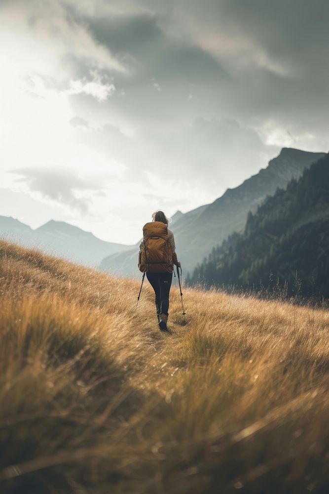 Woman hiking in the mountains adventure backpack walking.