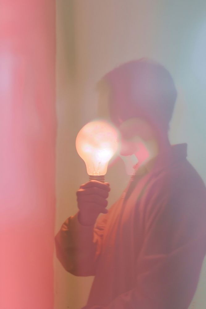 Person holding light bulb lighting adult red.