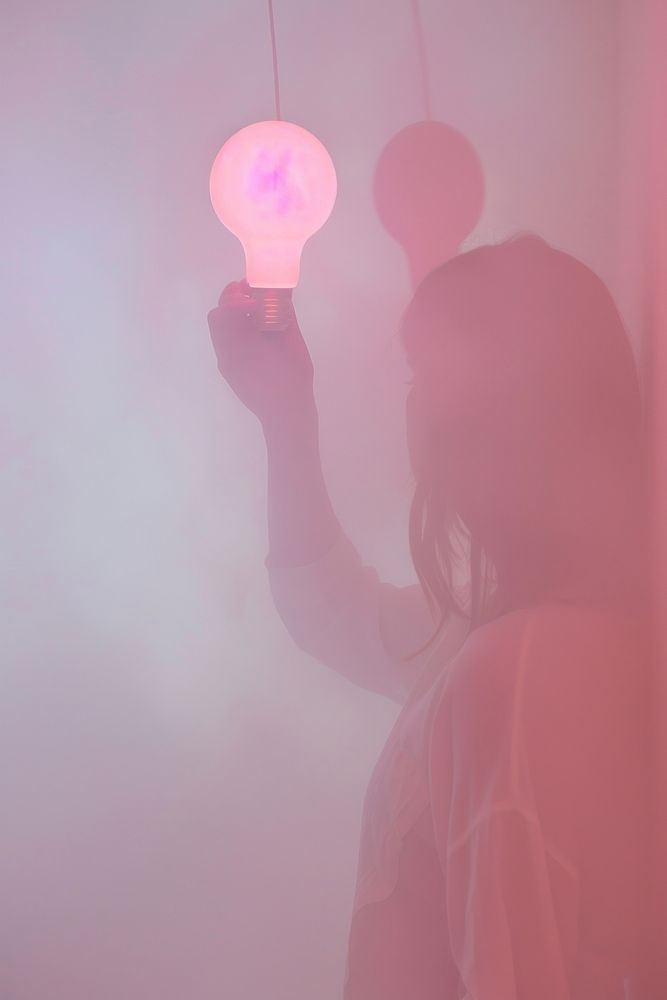 Person holding light bulb adult pink red.