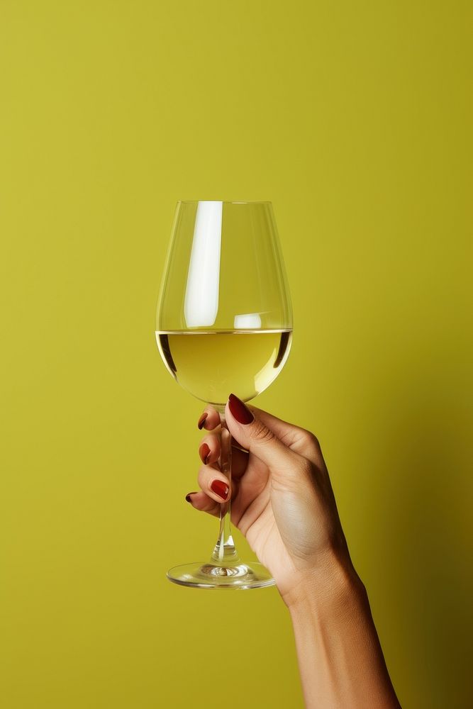 White wine glass holding bottle.