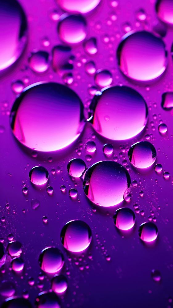 Water drops in neon lighting purple backgrounds abstract.