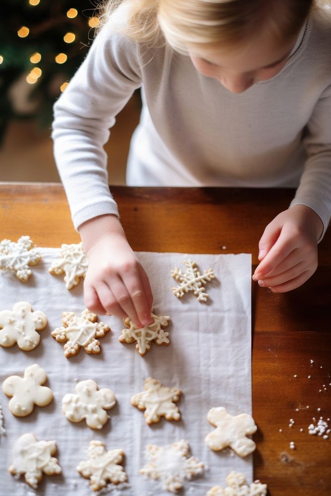 Photo of kid decorating cookies white food celebration.