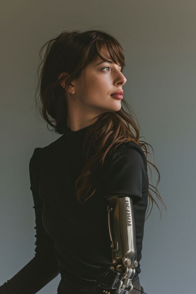 A woman with prosthetic arm portrait photo contemplation.
