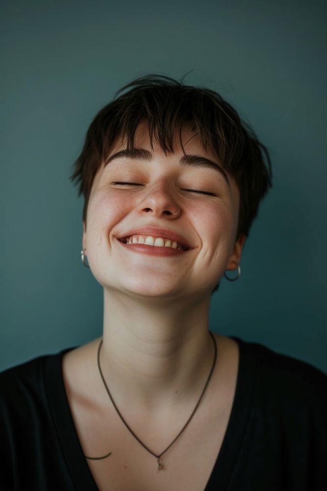 Autistic person necklace laughing portrait.