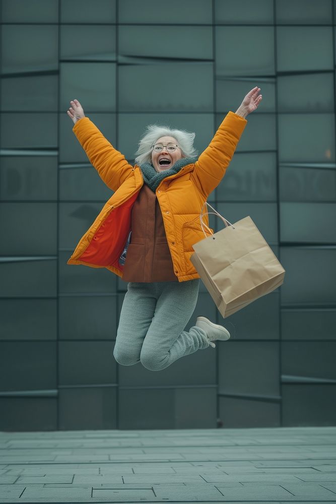 Happy mature woman jumping and holding a shopping bag photography portrait footwear.