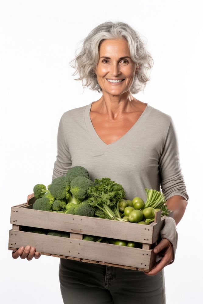 Mature Woman holding vegetable wodden box broccoli adult plant.