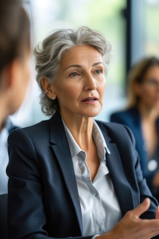 Mature businesswoman wearing a suit meeting office adult.