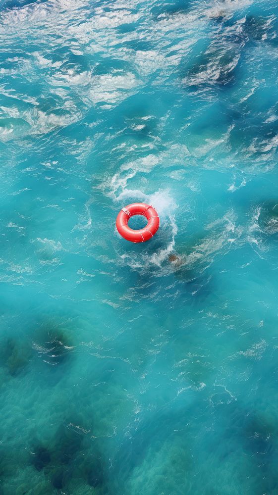 Red inflatable ring in the ocean swimming outdoors nature.