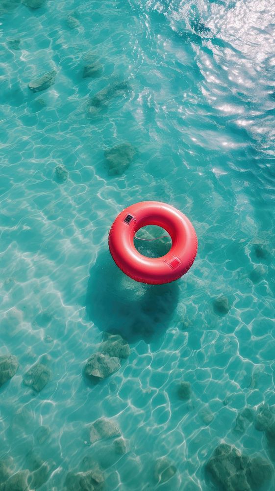 Red inflatable ring in the ocean outdoors nature sea.
