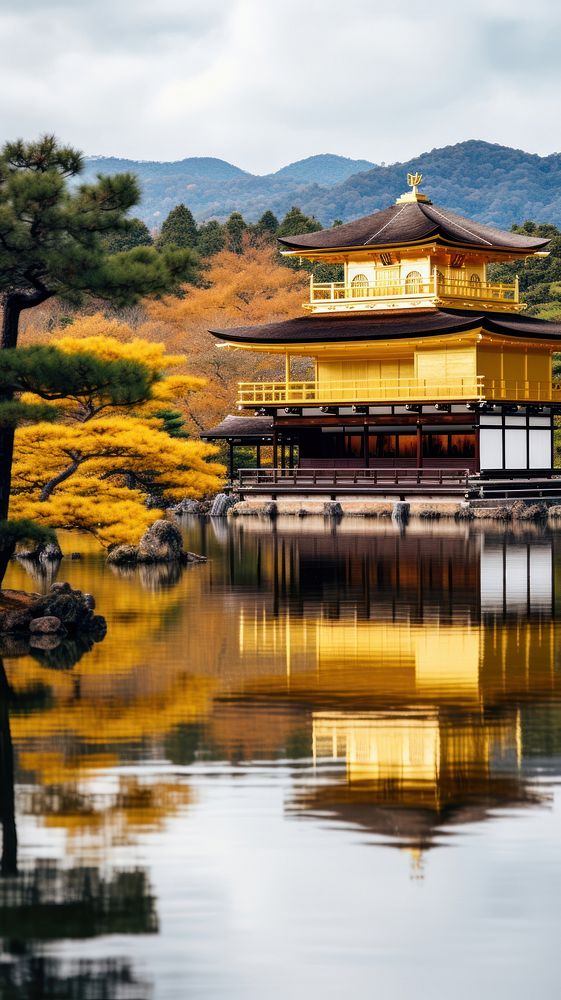 Japanese Golden temple by lake in wintertime architecture building outdoors.