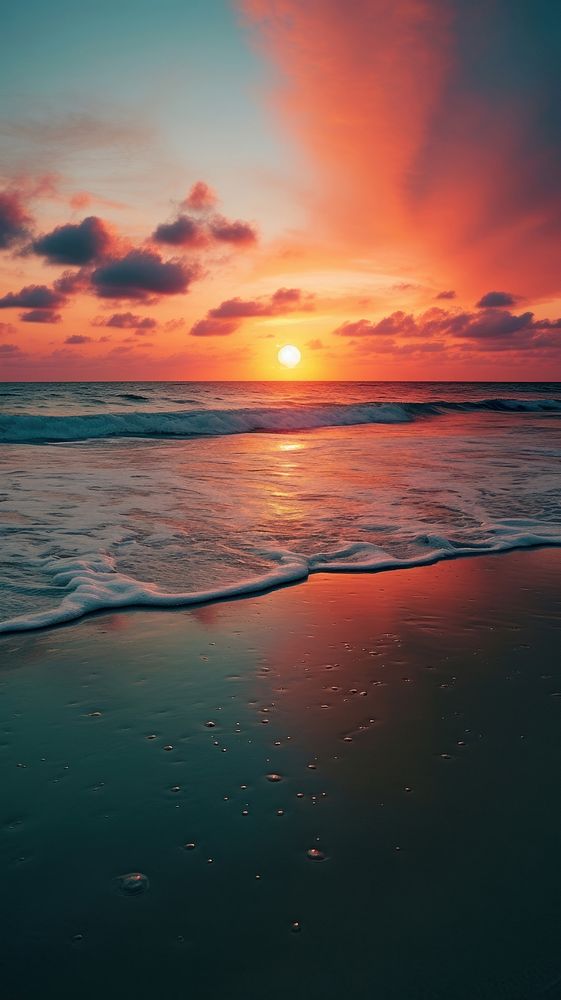 Sun is setting over the ocean beach outdoors horizon.