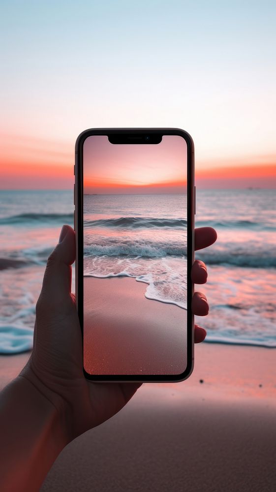 Woman using smartphone sea outdoors sunset.