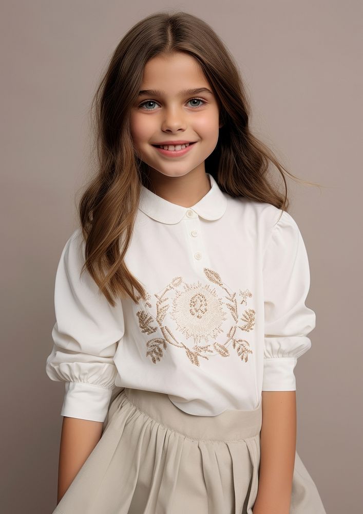 Cheerful kid wearing white embroidered polo sweatshirt and white contrast pleated skirt portrait sleeve blouse.