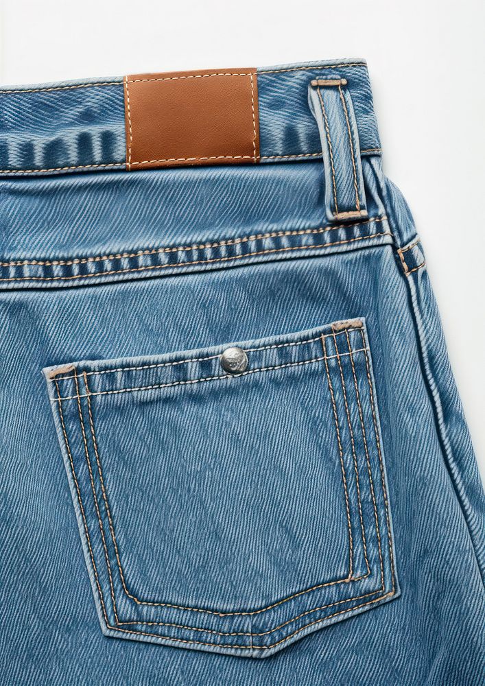 Back side pocket of blue jeans pants and add empty big label price tag backgrounds denim trousers.