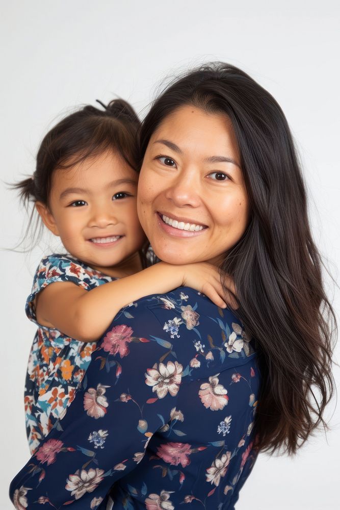 Happy asian mom with young girl portrait adult smile.
