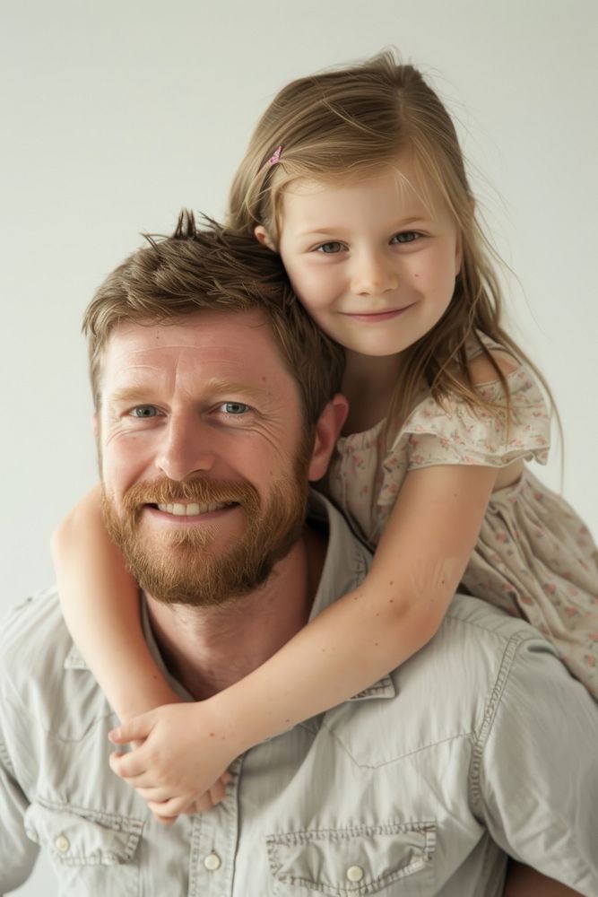 Happy father with young girl on back portrait adult child.