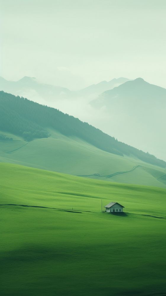 A cabin a green field with a valley landscape grassland outdoors.