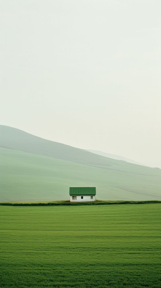 A cabin a green field with a valley outdoors horizon nature.
