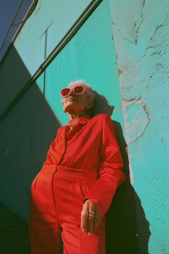 Old woman wearing red streetwear clothes portrait glasses photo.