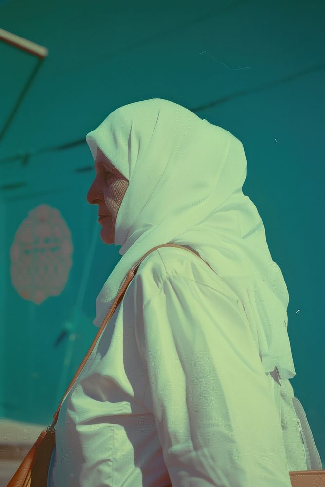 A old woman wearing white hijab and white streetwear clothes adult accessories headscarf.