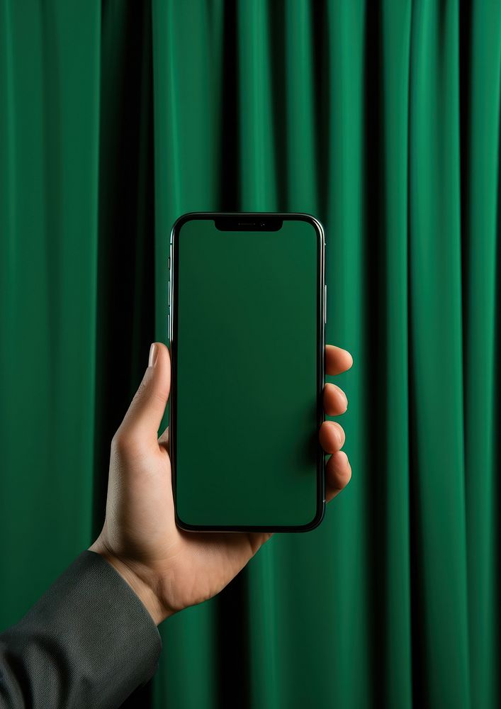 Curtain holding green phone.