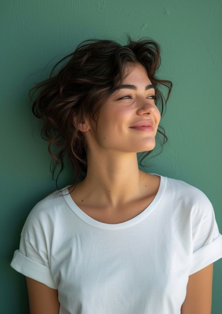 A happy woman wearing white t shirt smile blue contemplation.