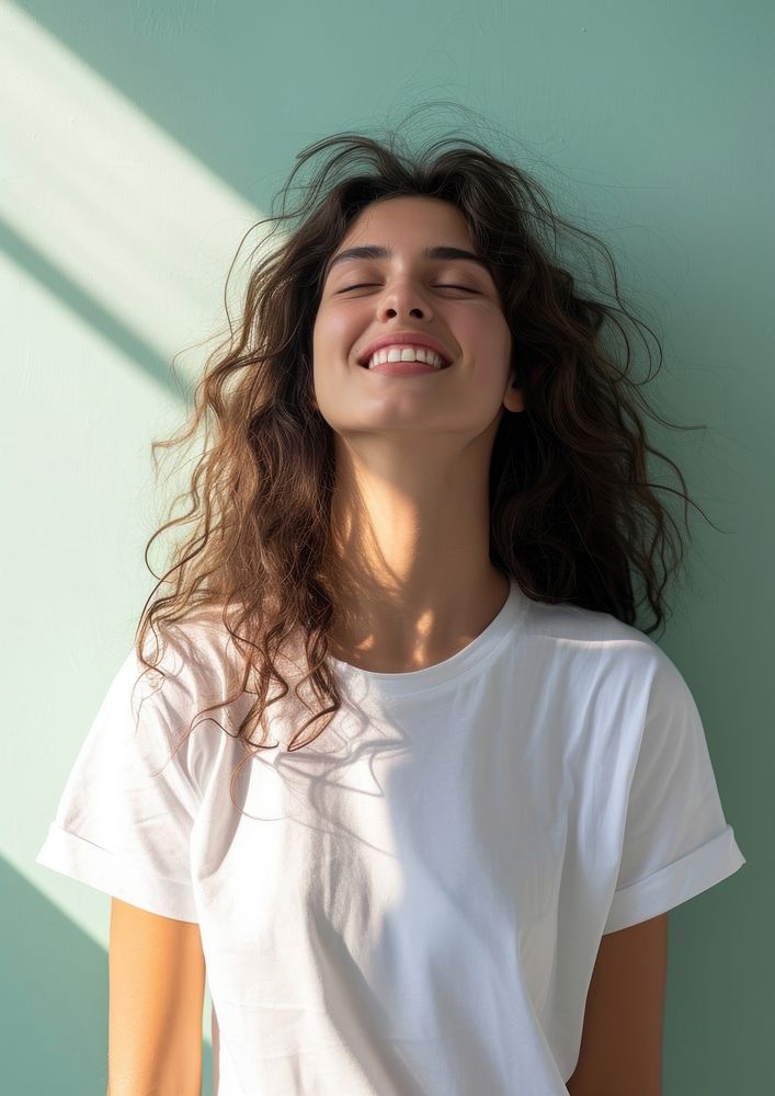 A happy woman wearing white t shirt laughing smile contemplation.