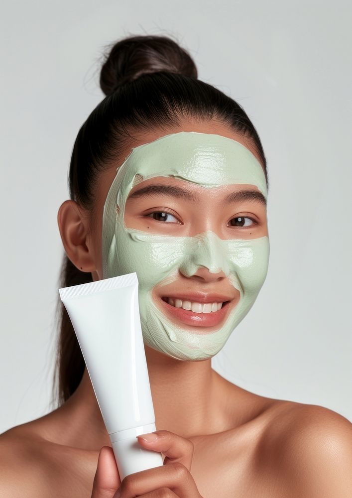 Young asian woman with organic mask portrait holding adult.