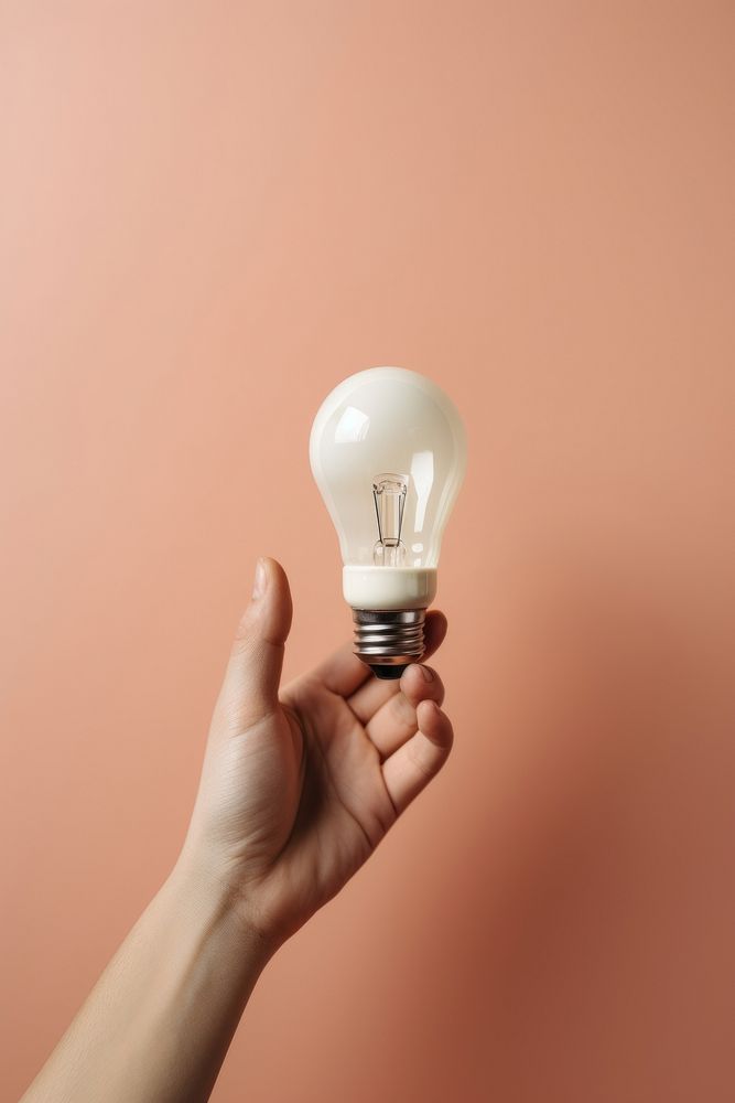 Lightbulb holding hand electricity.