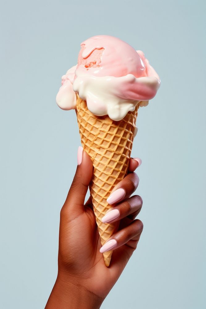 Hand holding ice cream cone dessert food freshness.