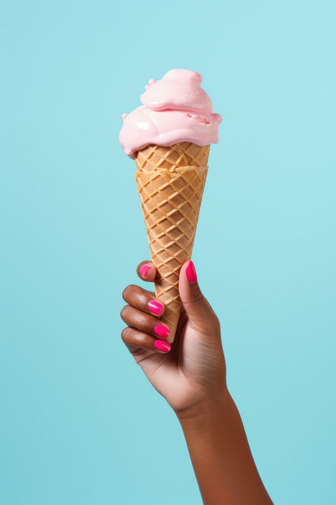 Hand holding ice cream cone dessert food freshness.