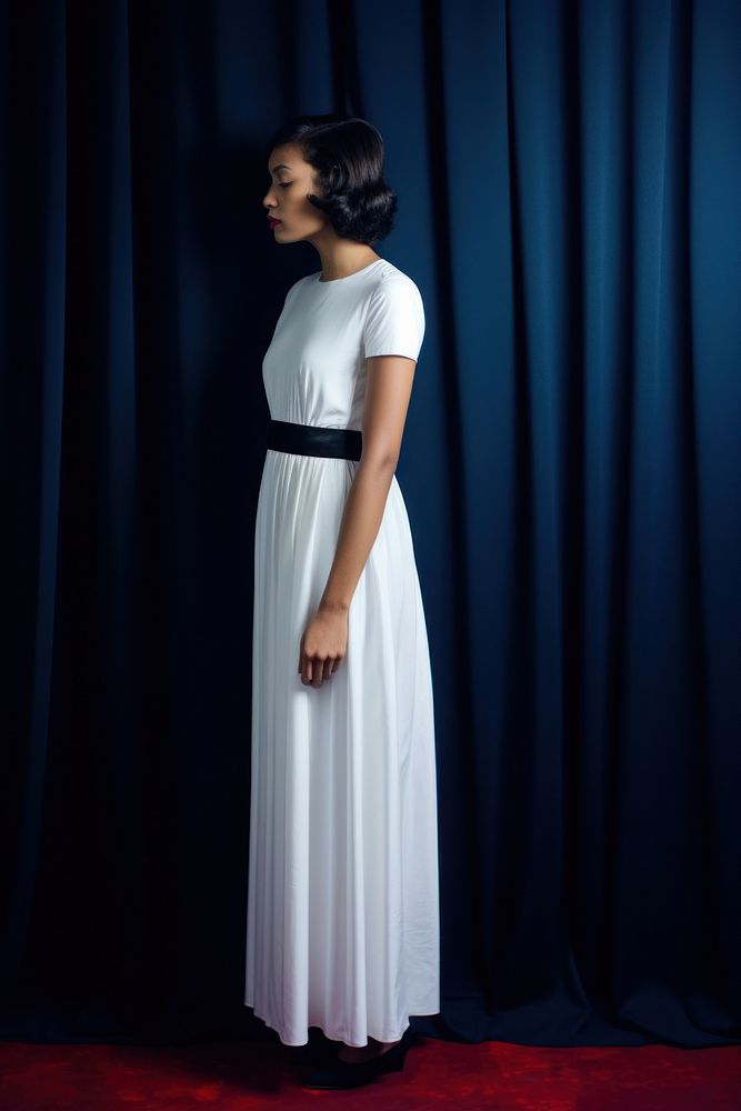 A half-america woman in a clean white dress standing curtain fashion.