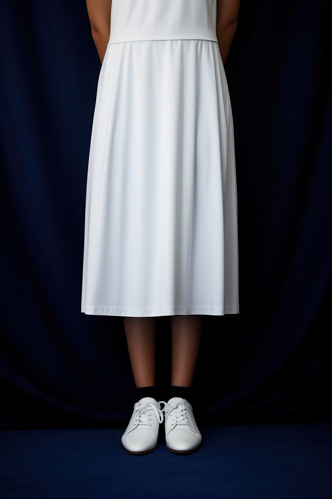 A half-america woman in a clean white dress footwear skirt shoe.