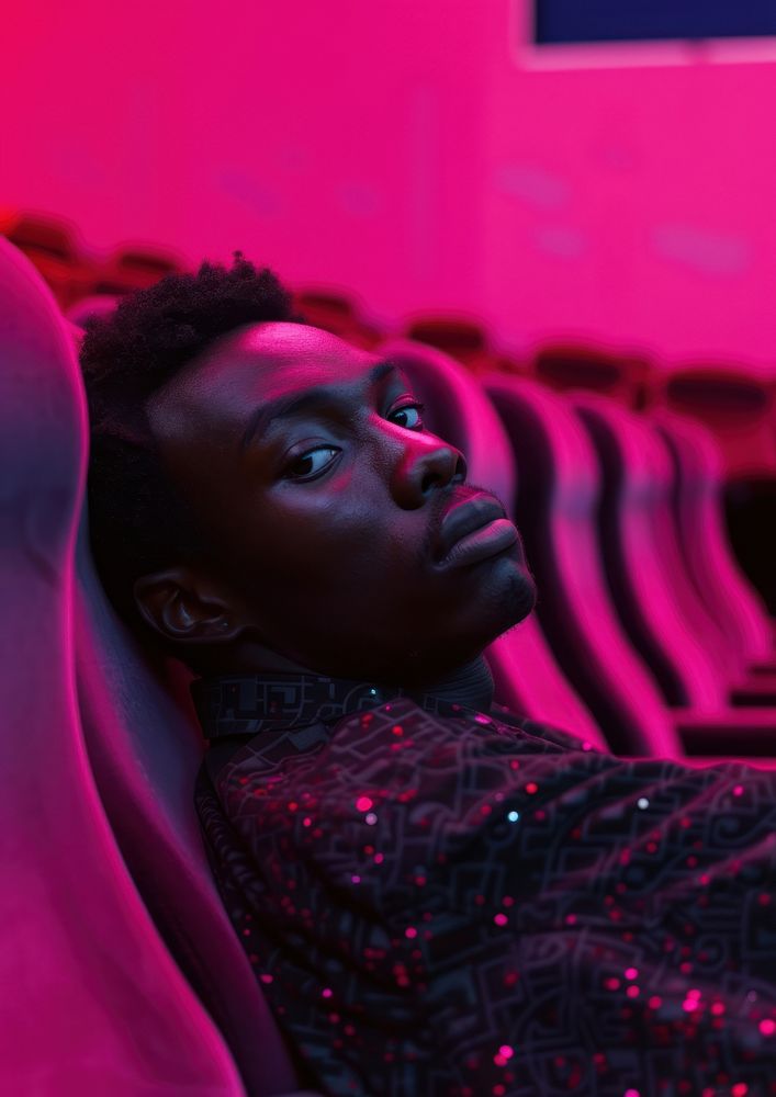 Black guy leaning on cinema seat in cinema portrait purple adult.
