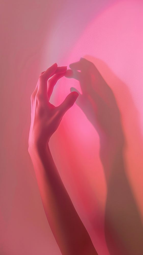Silhouette hands doing heart pose adult pink red.