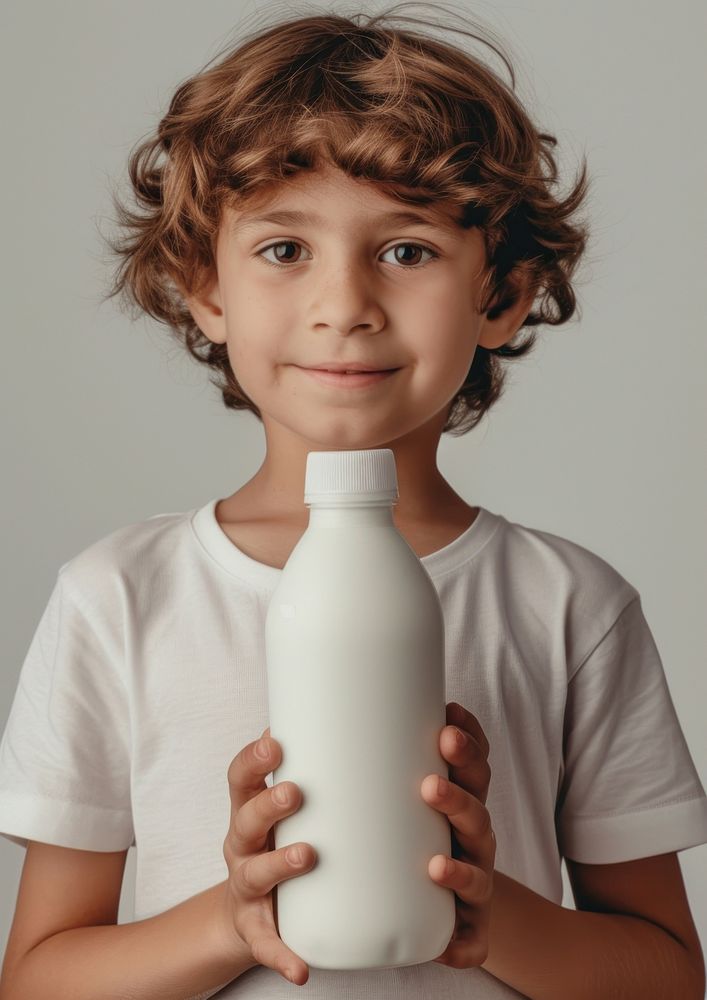 Kid holding a bottle of milk portrait photo refreshment.