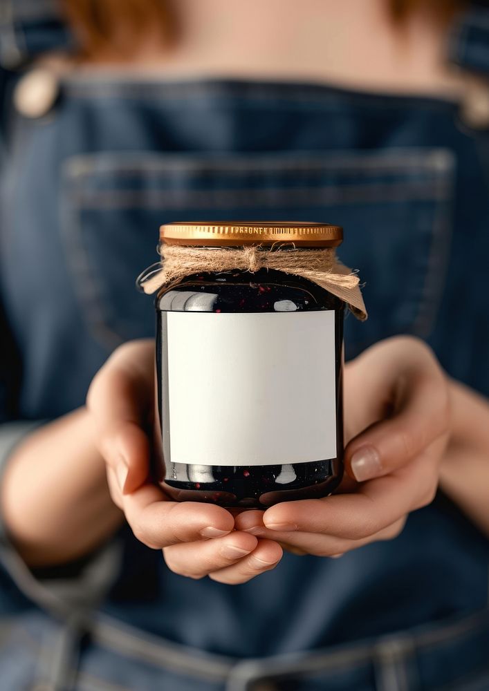 Woman holding a jar of blueberries jam midsection technology container.