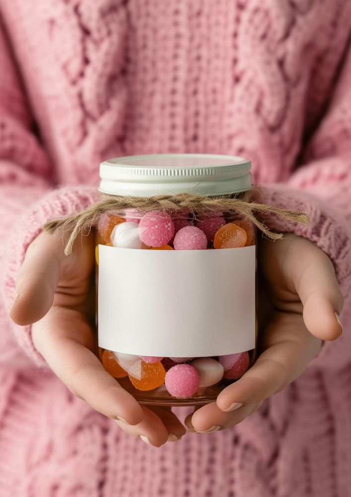 Woman holding a jar of candy food confectionery container.