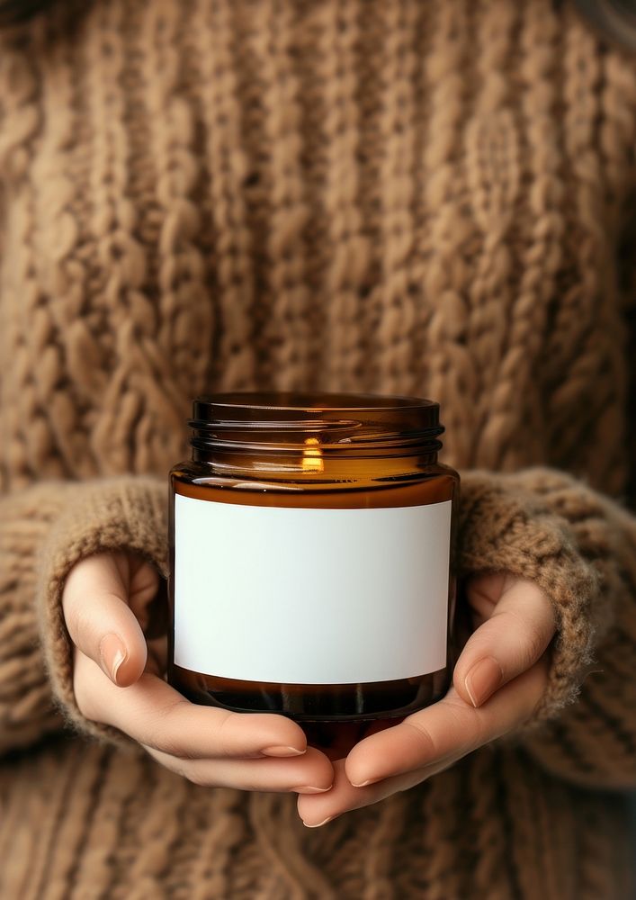 Woman holding a jar of candle midsection container lighting.